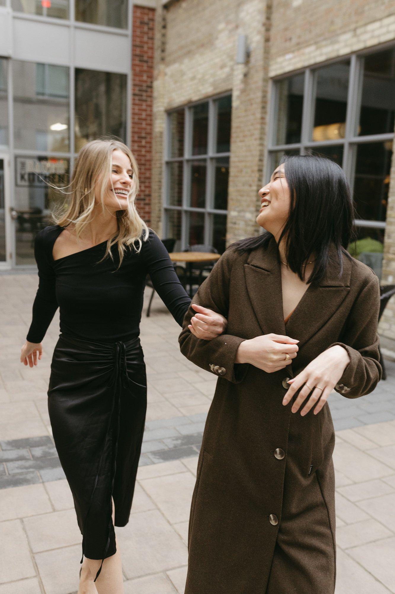 Two friends walking together in the city